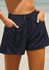 Model poses wearing navy elastic-waist side pockets lace-up board shorts