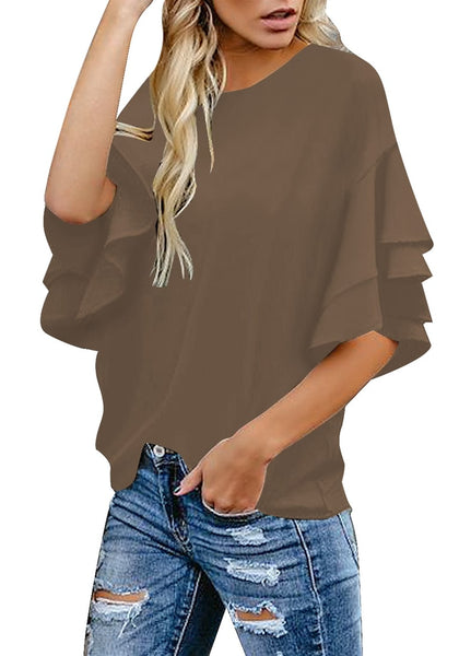 Angled shot of model wearing brown trumpet sleeves keyhole-back blouse