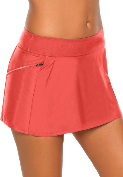 Model wearing coral zipper-pocket waistband skirted bikini bottom showing details