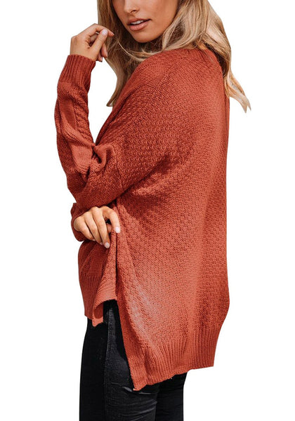 Side view of model in rust red ribbed knit textured side-slit sweater