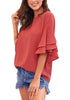 Side view of model wearing rust red trumpet sleeves keyhole-back blouse
