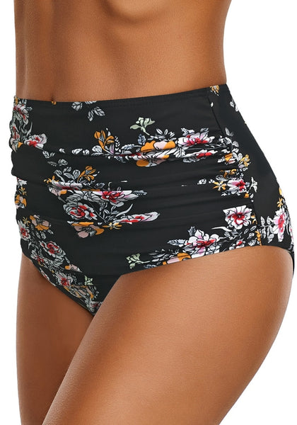 Side view of model wearing black floral-print high waist ruched swim bottom