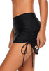 Side view of model wearing black side-tie mid-waist skirtini bottom